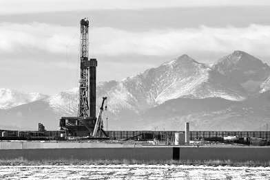 Drilling rig against mountain backdrop